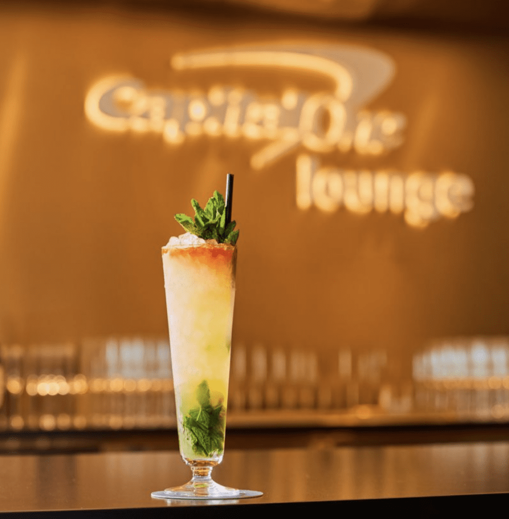 a glass of liquid with a straw